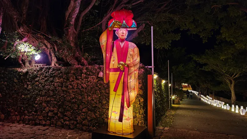 Illuminated traditional character lantern along a path at Murasaki Mura in Okinawa Japan