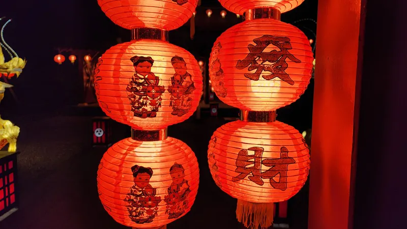 Red paper lanterns with decorative patterns hanging at night