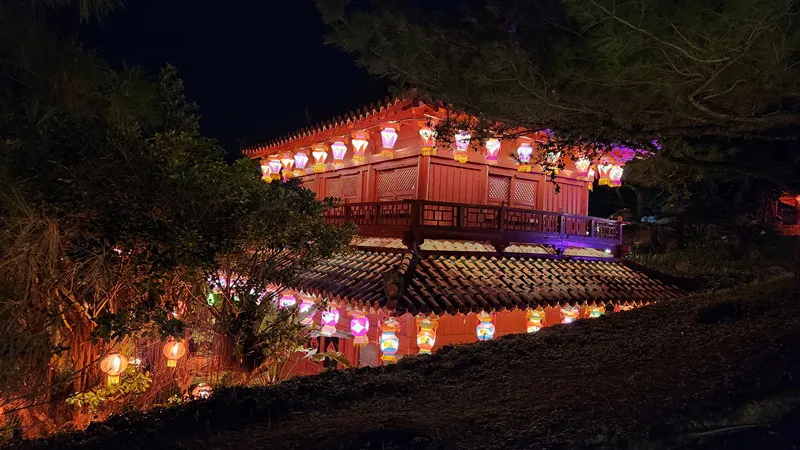 Traditional Okinawan building decorated with lanterns at night