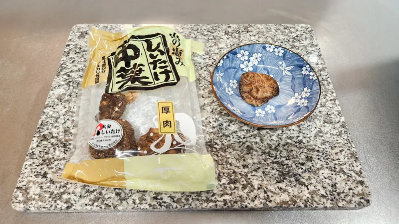 Dried shiitake mushroom next to its original Japanese package