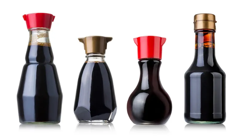 Several bottles of soy sauce with different shapes and caps