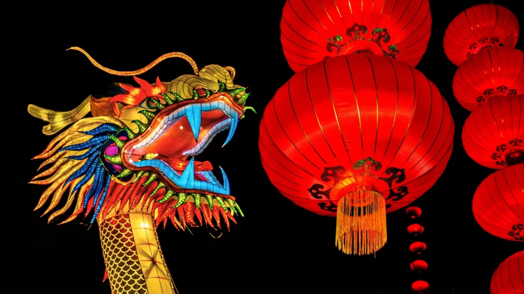 Colorful dragon lantern next to red paper lanterns at Murasaki Mura in Yomitan Okinawa Japan