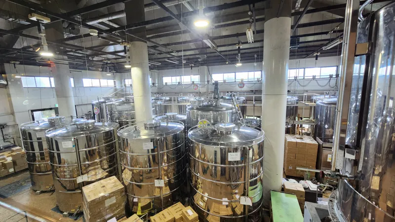 Rows of fermentation tanks inside Okinawa World’s awamori distillery